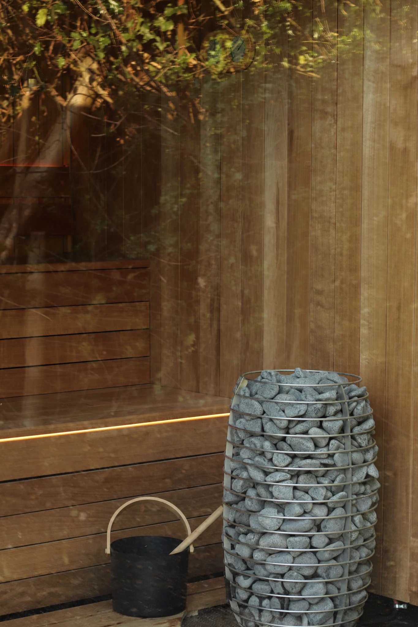 The Haze Sauna heater, stones and wooden bucket