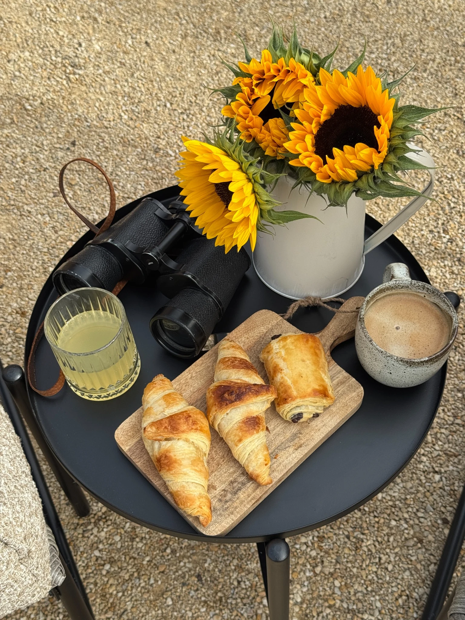 Croissants, coffee and flowers outside