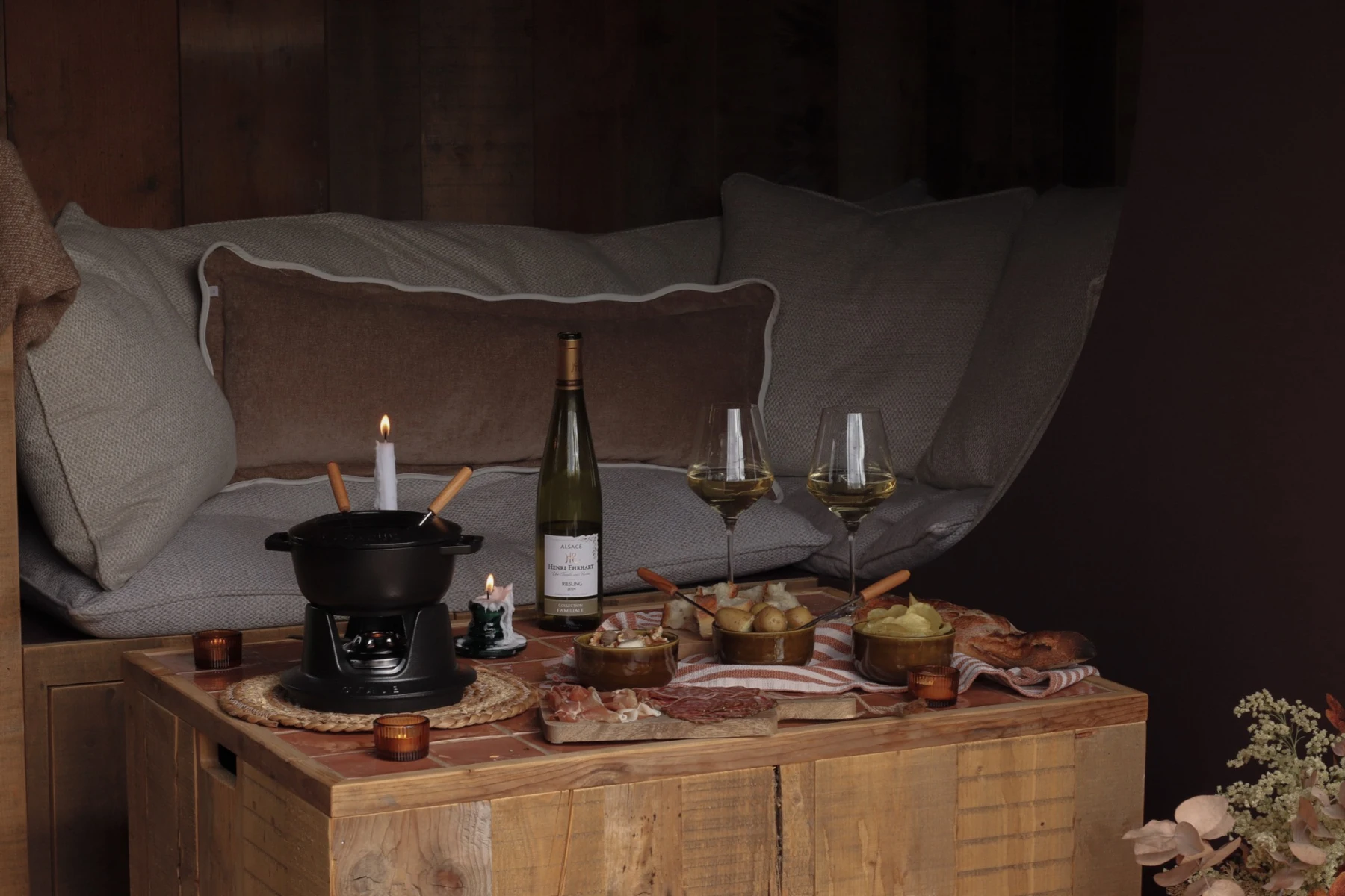Cheese fondue and wine beside the sofa